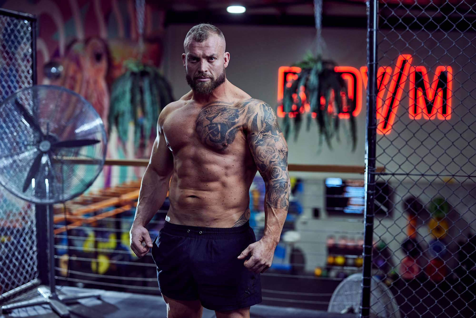 Coach Hall in the gym looking straight ahead with a serious expression on his face